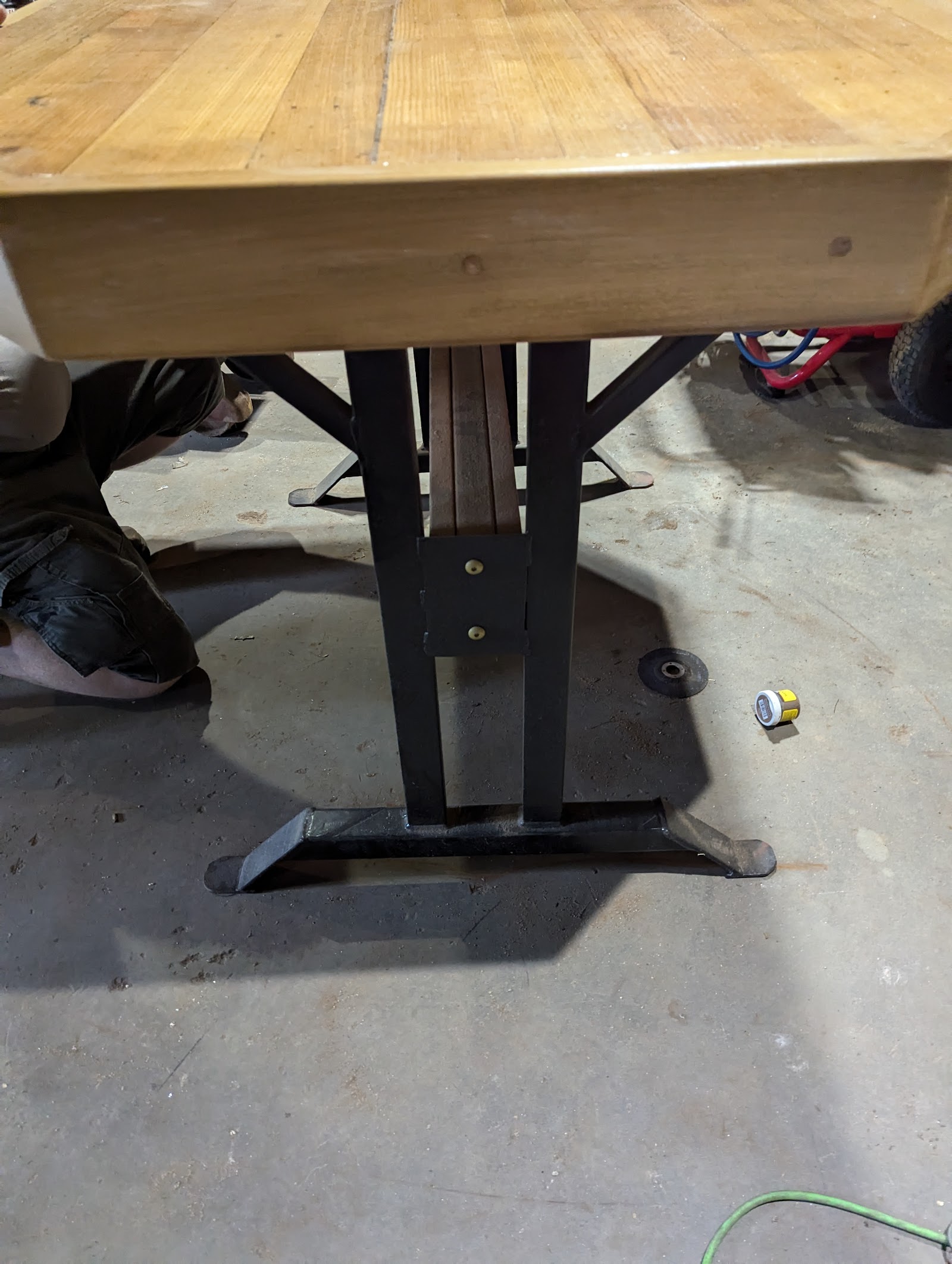 Table with forged steel pedestal base and wood top
