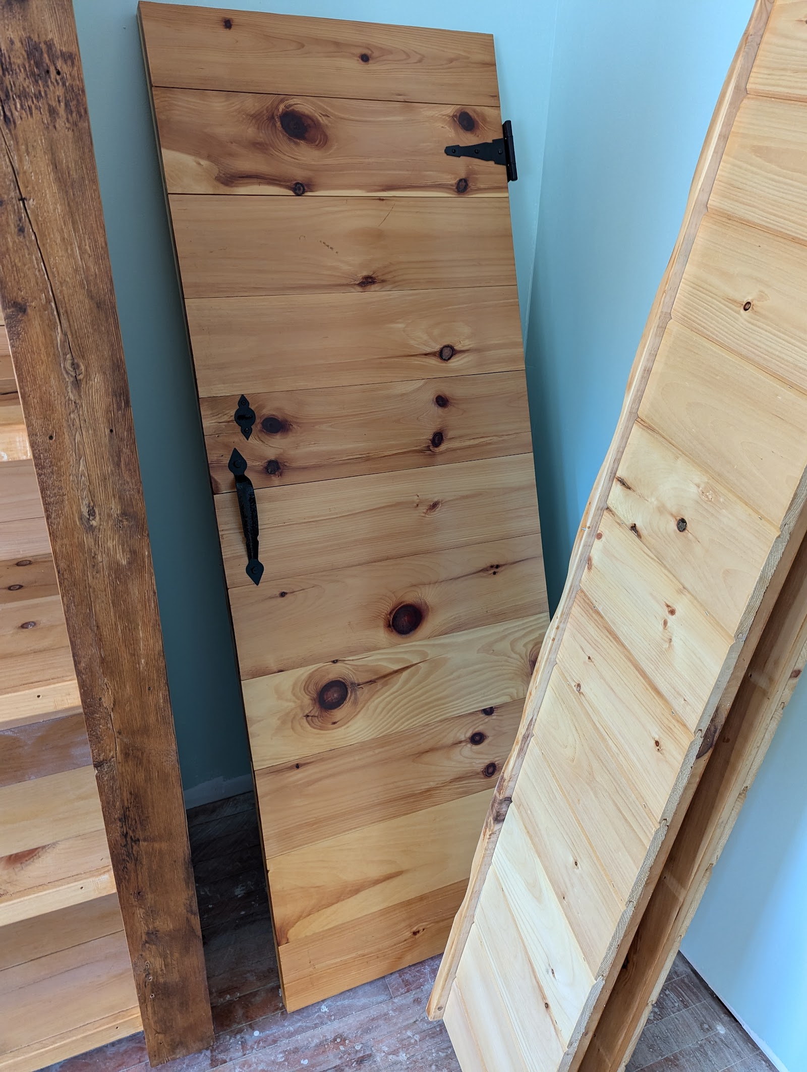 Handcrafted pine door with iron hardware
