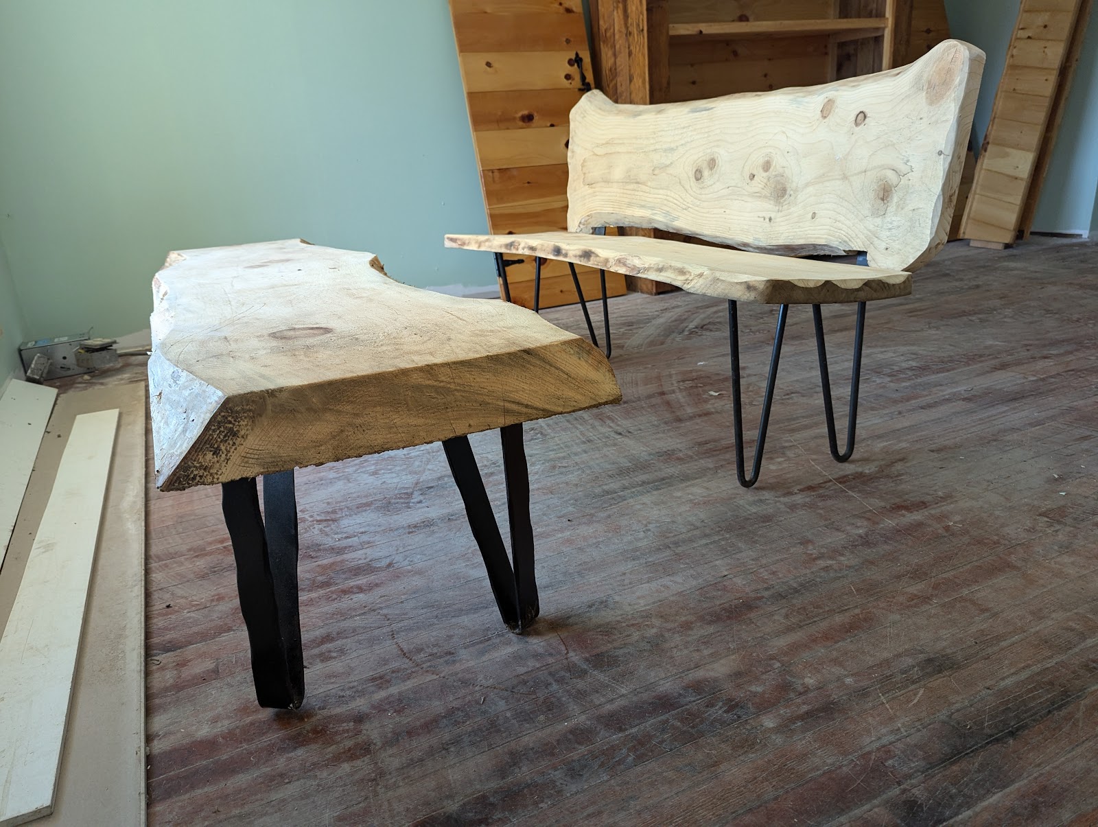 Live-edge wood tables on hand-forged metal hairpin legs