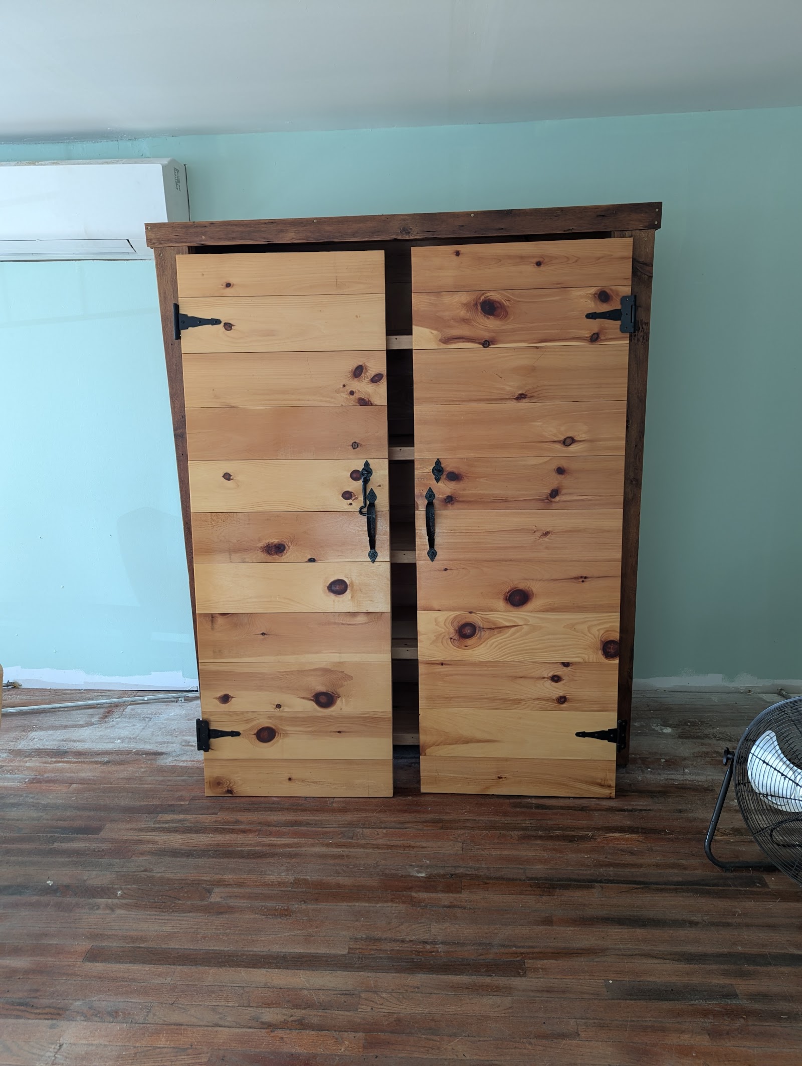 Knotty pine cabinet with iron strap hardware